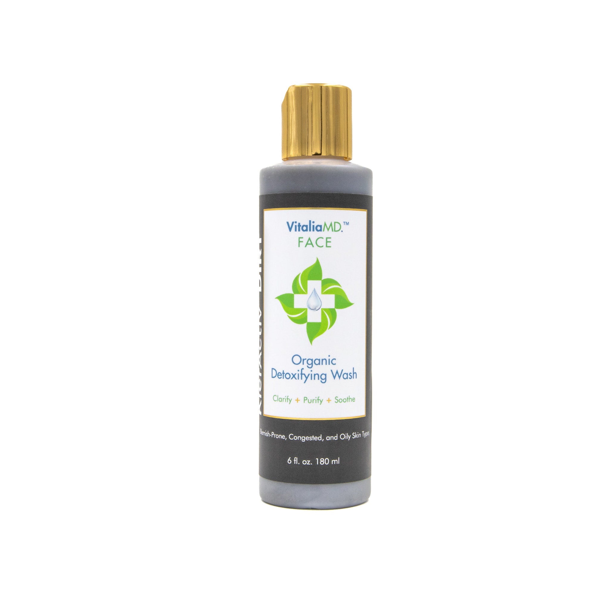 Facial cleanser bottle with gray and gold cap, VitaliaMD text visible, for face
