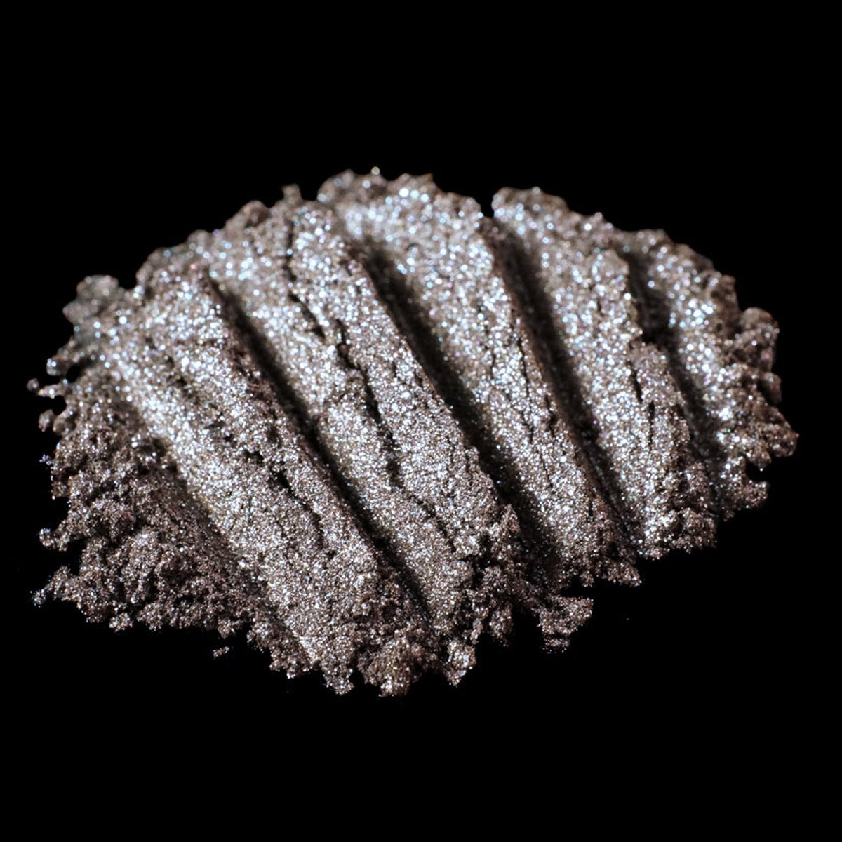 Metallic brown loose pigment eyeshadow with silver and blackened gold glitter in a sleek jar