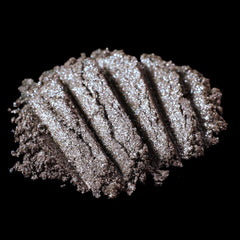 Metallic brown loose pigment eyeshadow with silver and blackened gold glitter in a sleek jar