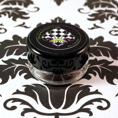 Swatch of Cool Bronze loose pigment eyeshadow showing metallic brown base with silver and blackened gold glitter flecks