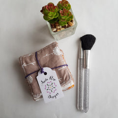 Washable face wipes, tan floral pattern fabric, tied with purple string, Anita Rose Designs tag