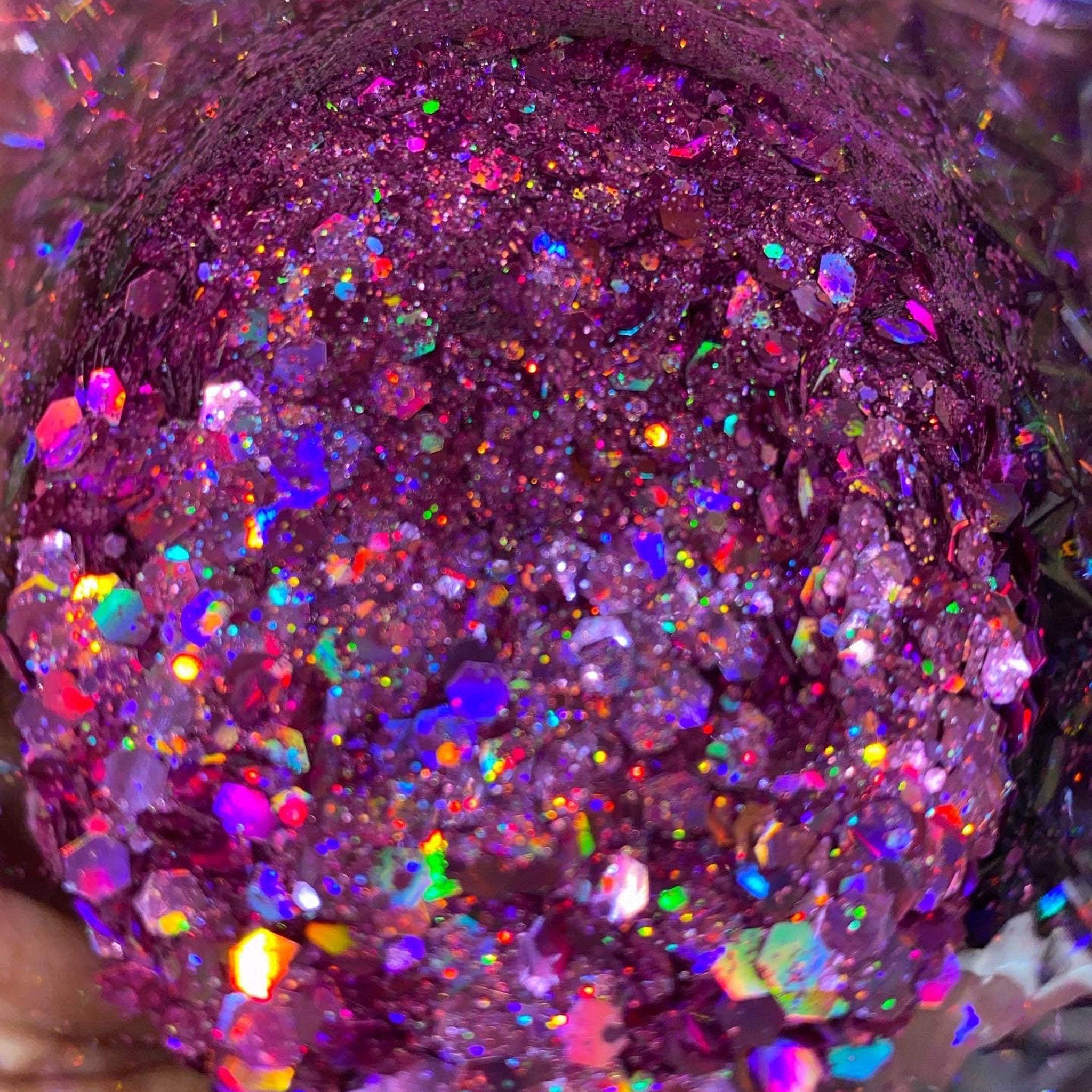 Assorted iridescent chunky glitter pots in rainbow hues with reflective shimmer for eye makeup and nails