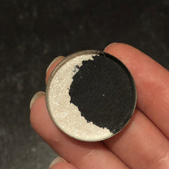 Close-up of shimmering silver-blue eyeshadow in crescent moon shape with smooth satin finish