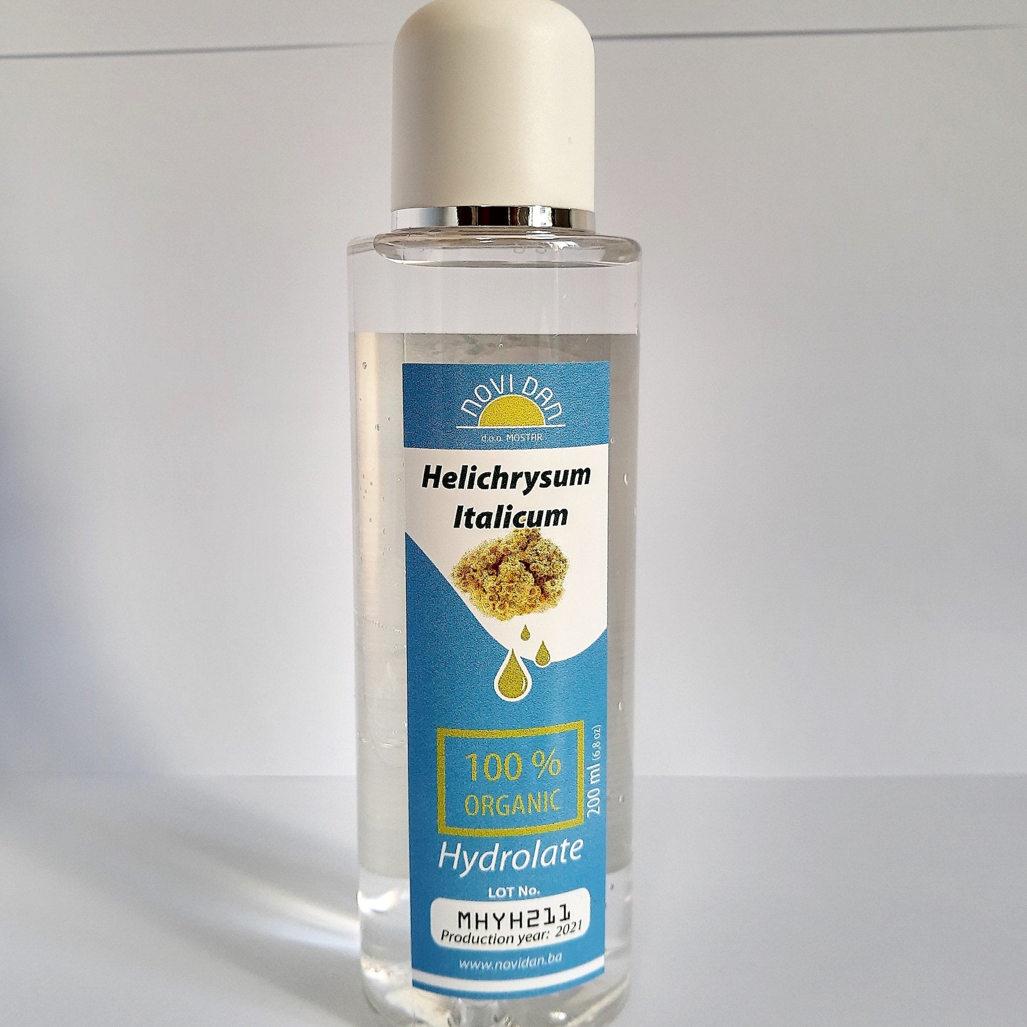 Hydrolate bottle with clear liquid, white cap, and blue label with text "NOVI DAN" and "Hydrolate