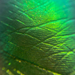 Close-up of Honeydew Lillet Opal loose pigment eyeshadow showing sparkling multichrome color shift from gold to green