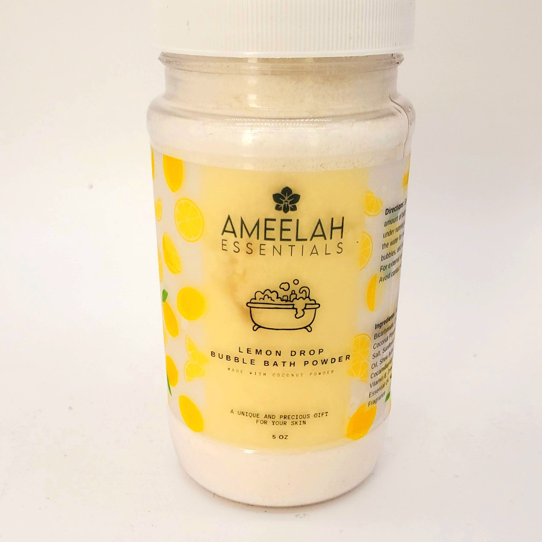 Bubble bath powder in clear jar with yellow label, lemon pattern, and AMEELAH Essentials text