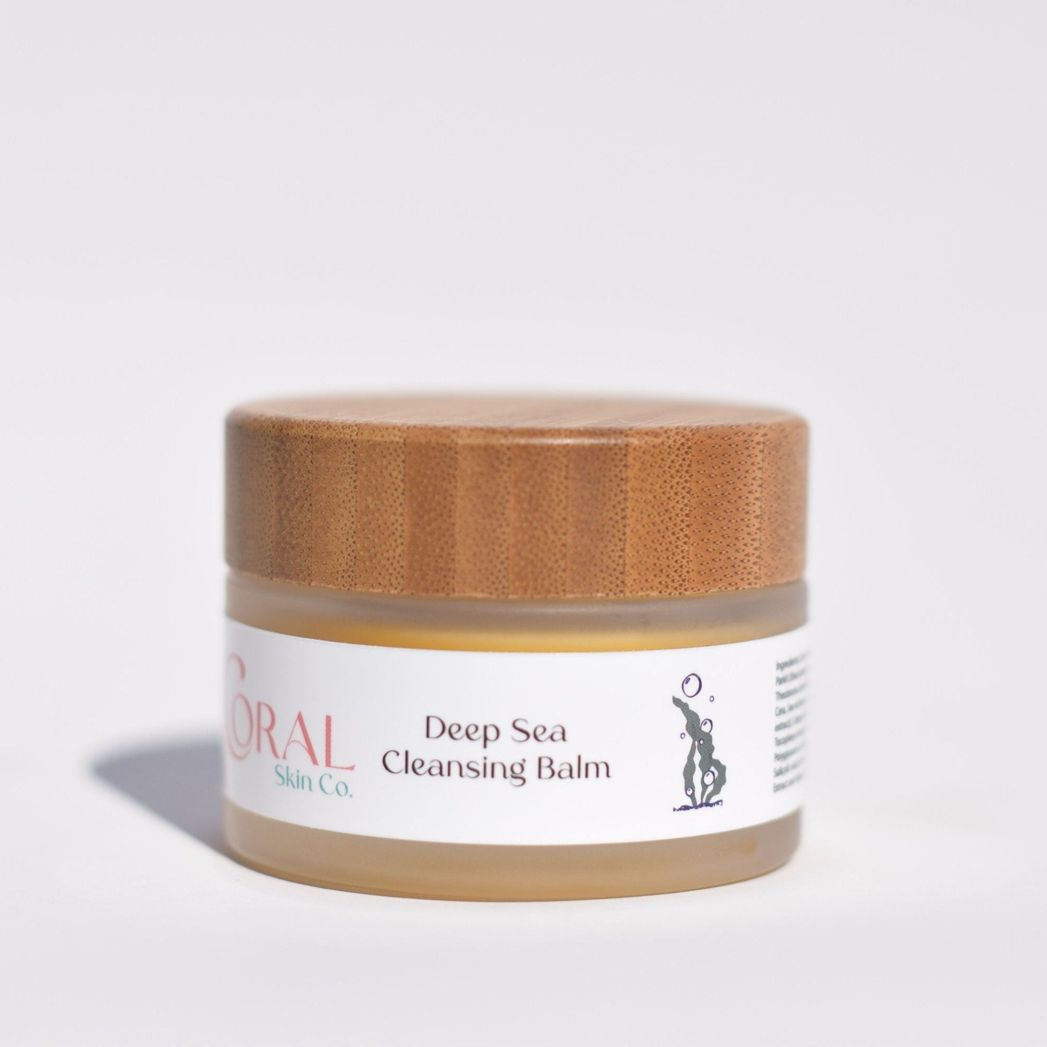 Cleansing balm jar with wooden lid, glass jar, and Coral Skin Co. label