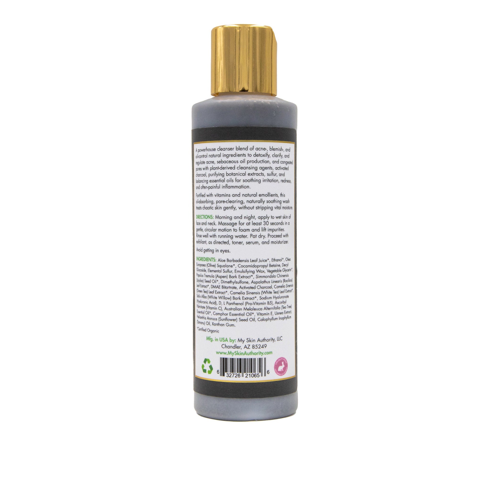 Charcoal cleanser bottle with gold cap, gray and black label, standing upright