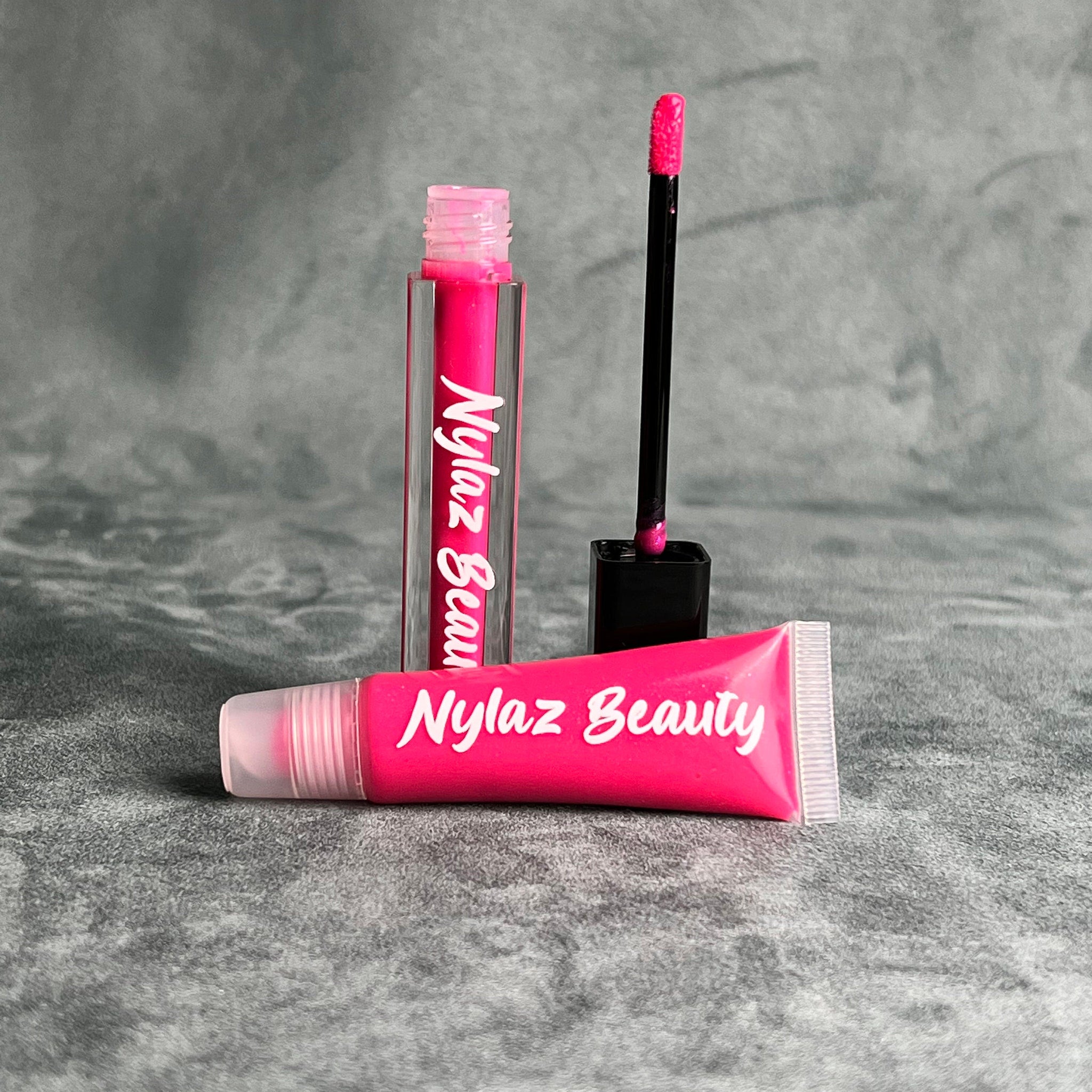Lip gloss tubes with pink gloss, black applicator, and Nylaz Beauty text.