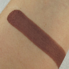 Close-up of matte pressed eyeshadow pan showing smooth pigment texture in a neutral shade