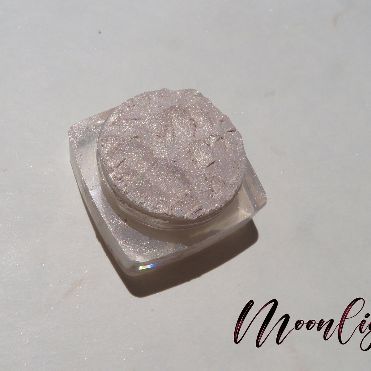 Pale yellow loose mineral eyeshadow with golden shimmer in a small round jar, vegan and cruelty-free.