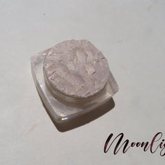 Pale yellow loose mineral eyeshadow with golden shimmer in a small round jar, vegan and cruelty-free.