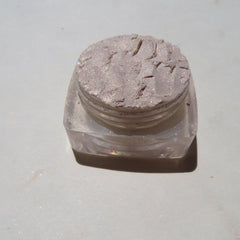Hand applying pale yellow shimmer loose powder eyeshadow with a brush for a golden glow