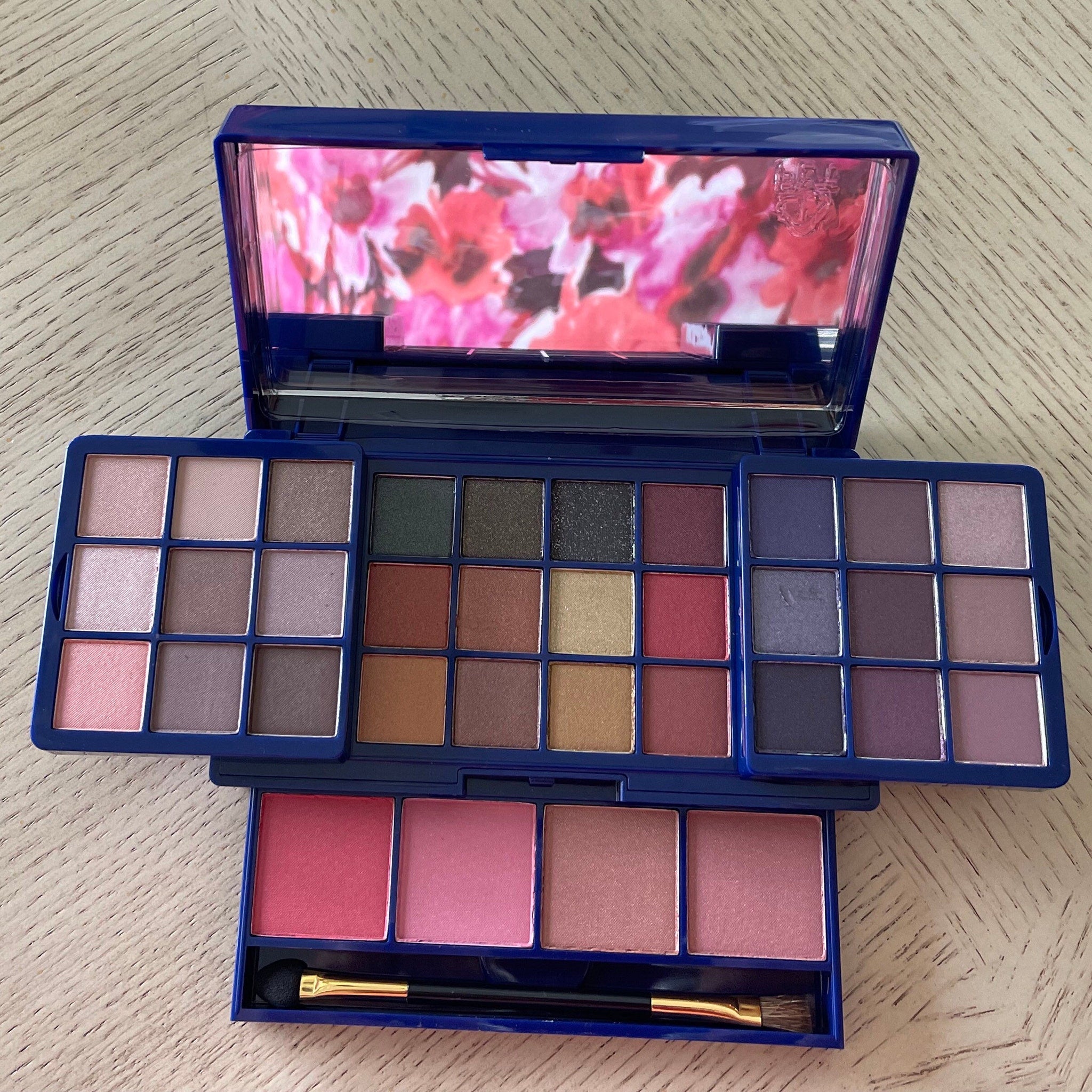 Side view of Avon Glimmer Glow Up palette showcasing 12 shimmering eyeshadow shades in a sleek black compact