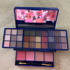 Side view of Avon Glimmer Glow Up palette showcasing 12 shimmering eyeshadow shades in a sleek black compact