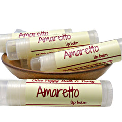 Lip balm tubes with beige labels, red text, and clear plastic packaging, Amaretto flavor