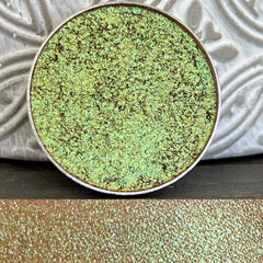 Pressed holographic eyeshadow compact with multi-chrome shifting colors in iridescent finish