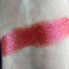 Close-up of fingertips applying shimmery bronze eye shadow from Mars palette to eyelid crease