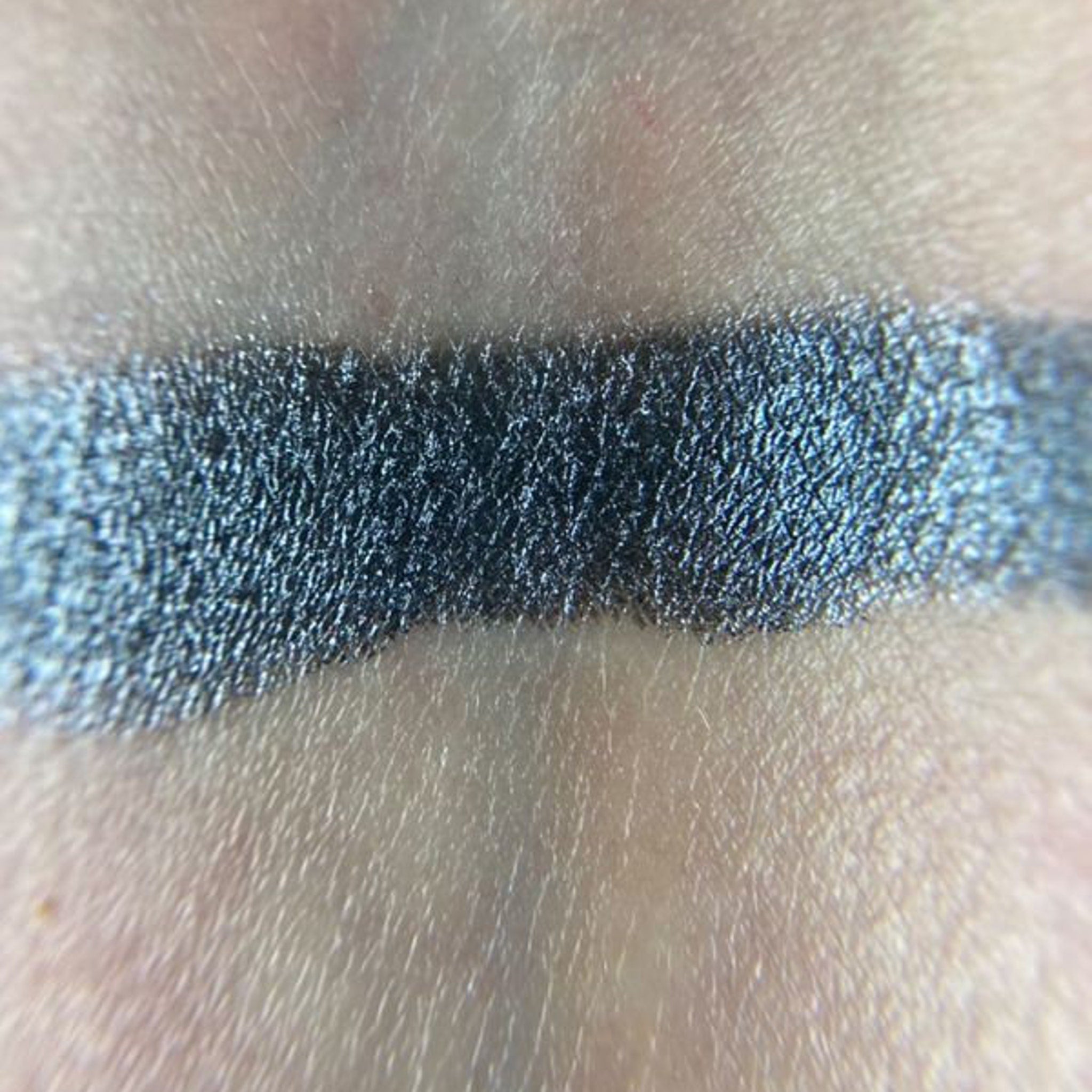 Side view of Demogorgon Eye Shadow Palette showcasing twelve vibrant matte and shimmer shades in sleek black packaging