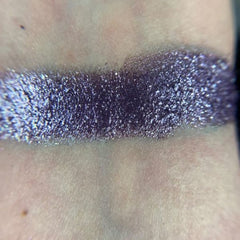 Side view of Constellation Eye Shadow Palette showcasing twelve shimmering shades in cosmic hues with sleek black case