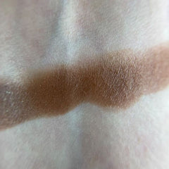 Close-up of vibrant matte and shimmer eyeshadow pans in warm neutrals and bold jewel tones
