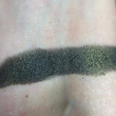 Side view of Black Flame Candle Eyeshadow Palette showing matte and shimmer shades in dark hues
