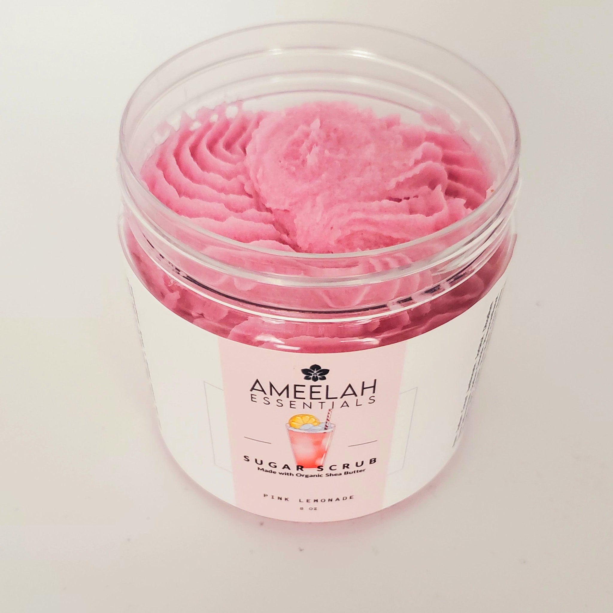 Sugar scrub jar with pink, textured contents and Ameelah Essentials label visible