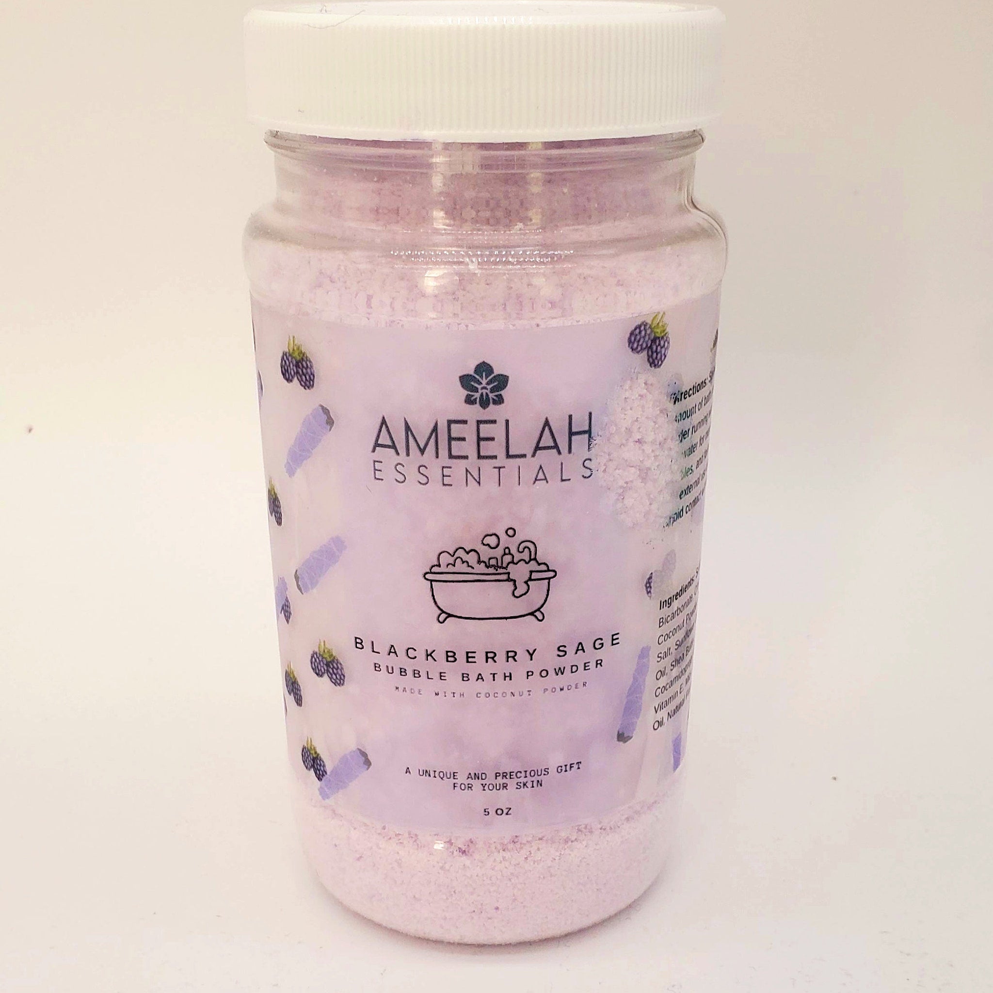 Bubble bath powder in a clear plastic jar with white lid, pink powder, and Ameelah Essentials label with blackberry design