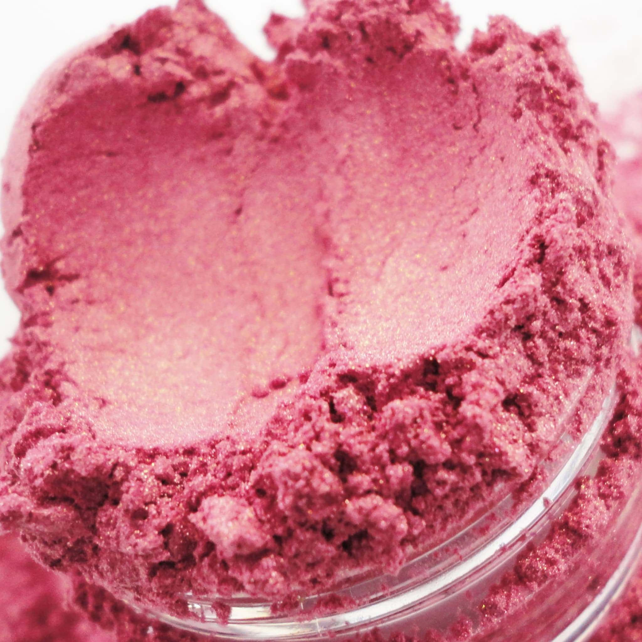 Pink powder with glitter, in a clear jar, close-up view