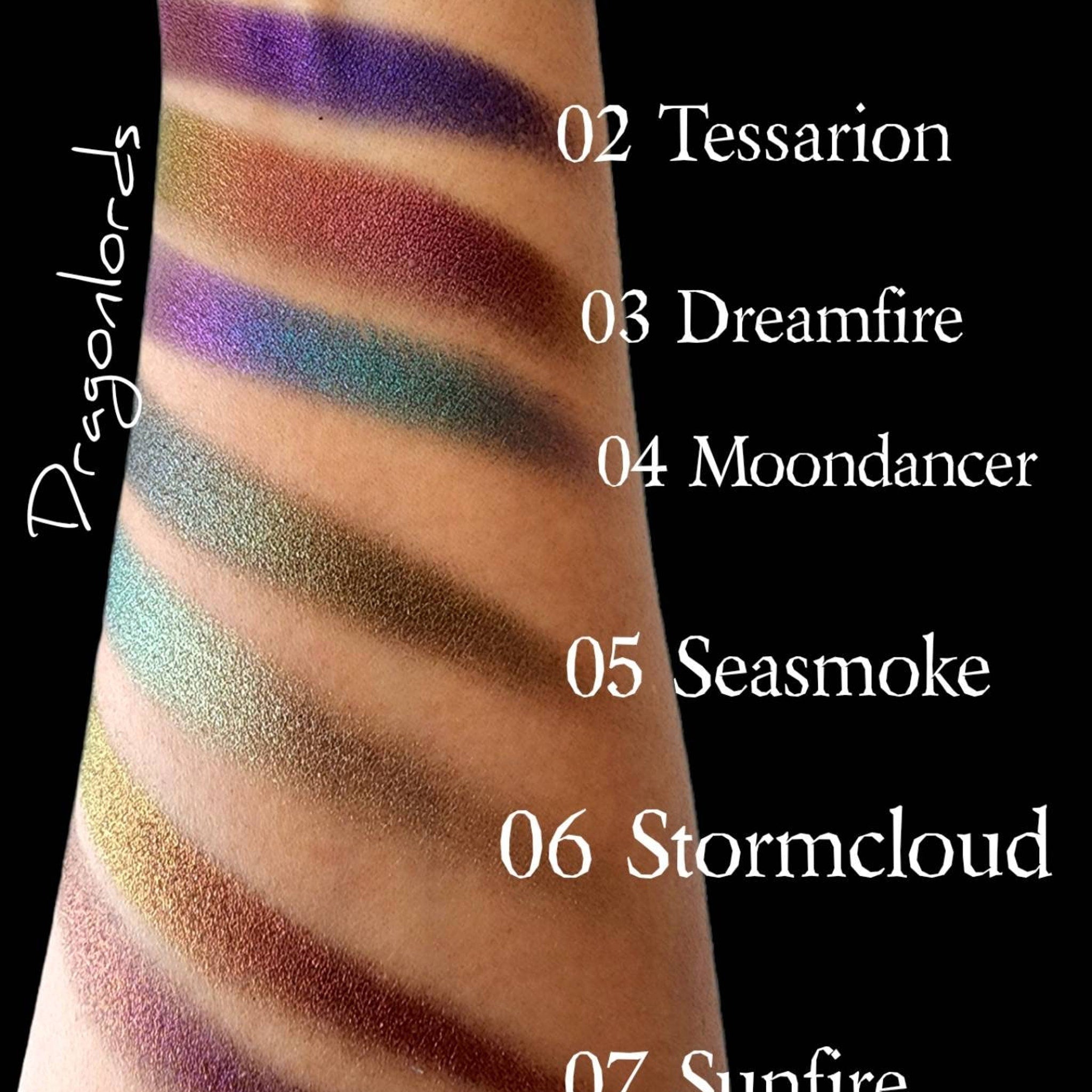 Eyeshadow swatches with metallic finish in purple, green, and brown colors on skin, Dragonlords text visible
