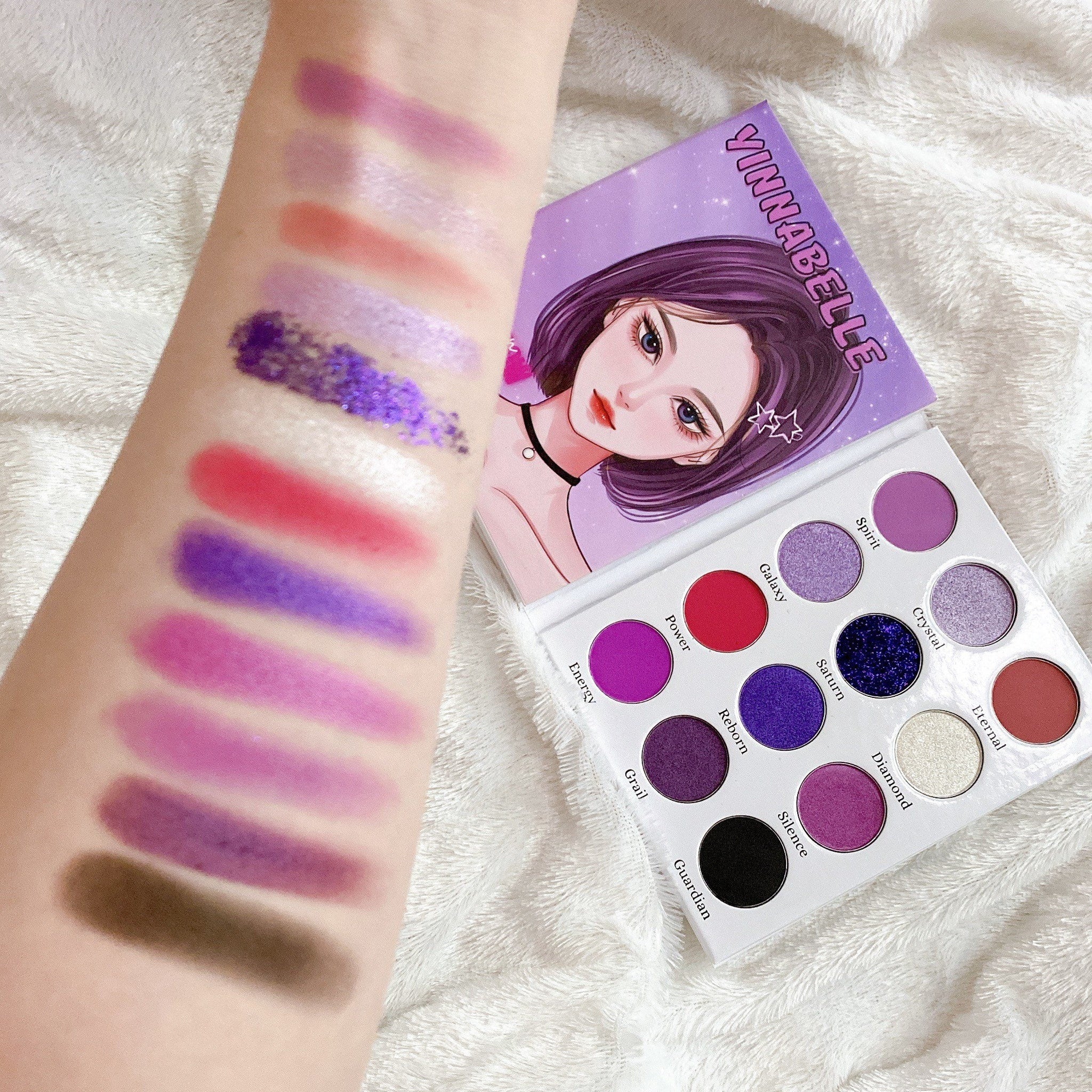 Close-up of deep purple and lavender eyeshadows with shimmer finish in Kawaii Gothic palette, showcasing velvety texture