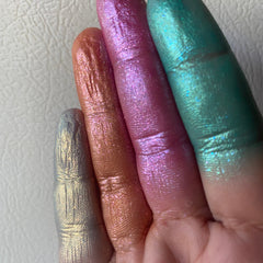 Close-up of metallic moon water eyeshadow pan showing iridescent silver and blue shimmer particles