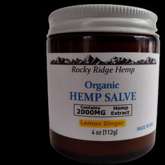 Body balm jar with white label, brown glass, and silver lid, Hemp Roots brand visible