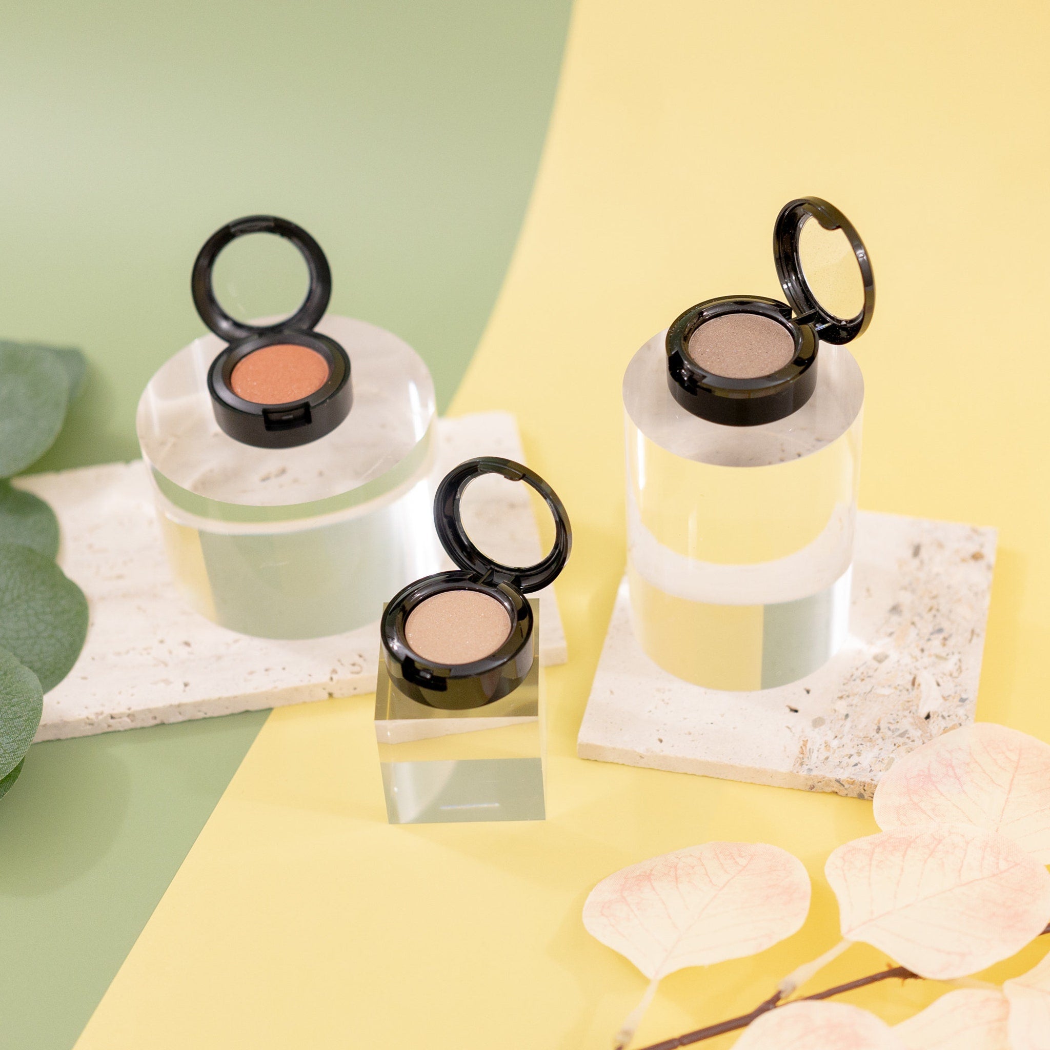 Close-up of Sunset Peach eyeshadow pan showing sheer orange sequin texture and mineral shimmer particles