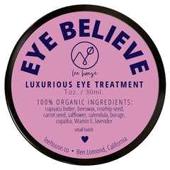 Eye balm, round container with pink label, black rim, and EYE BELIEVE text