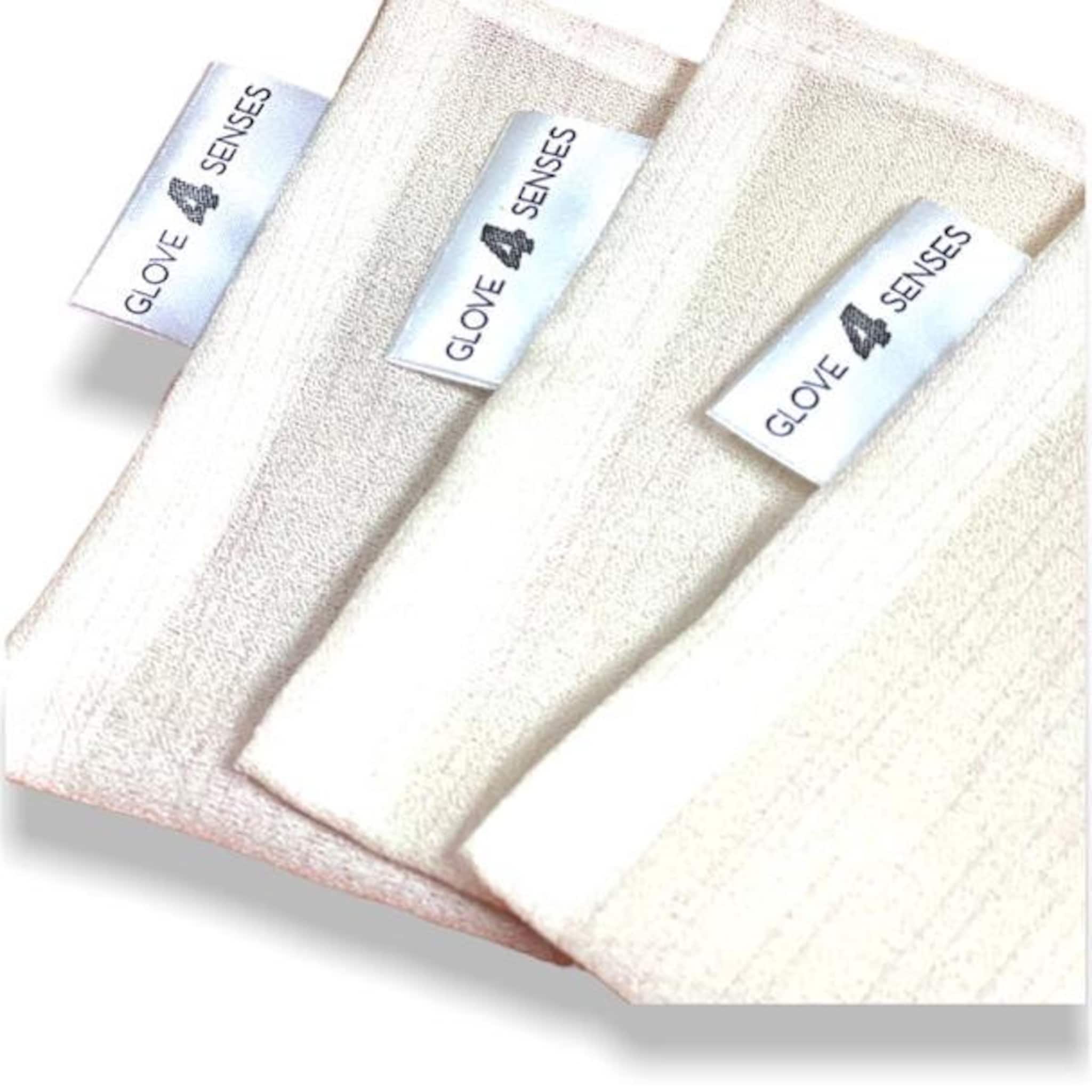 White fabric with textured pattern and "GLOVE 4 SENSES" label visible