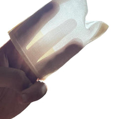 Sheer fabric, cream color, held in hand, showing texture and light