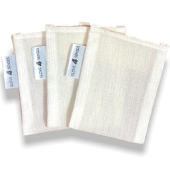 Facial exfoliating gloves, off-white fabric with vertical texture, 4 Senses brand tag attached