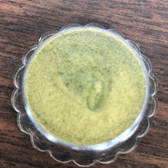 Close-up of creamy golden eyeshadow with soft shimmer in vintage Avon compact
