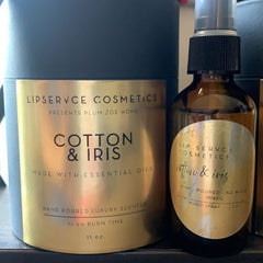 Candle and spray bottles with gold labels, dark blue container, "Cotton & Iris" scent, Lip Servce Cosmetics brand