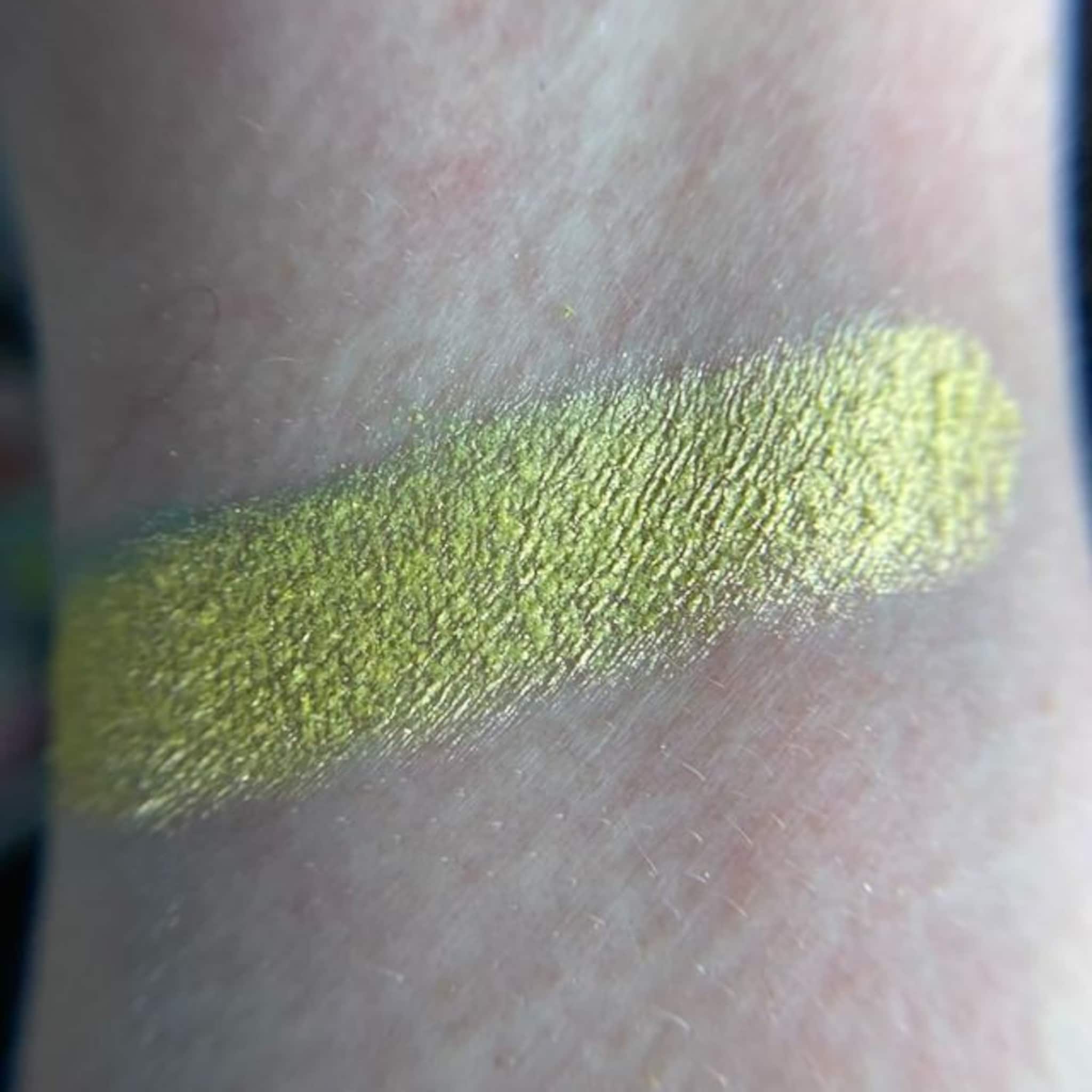 Eyeshadow swatch, metallic green with textured finish on skin