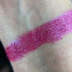 Close-up of Tickle Eye Shadow pan showing vibrant pink shimmer with smooth satin finish