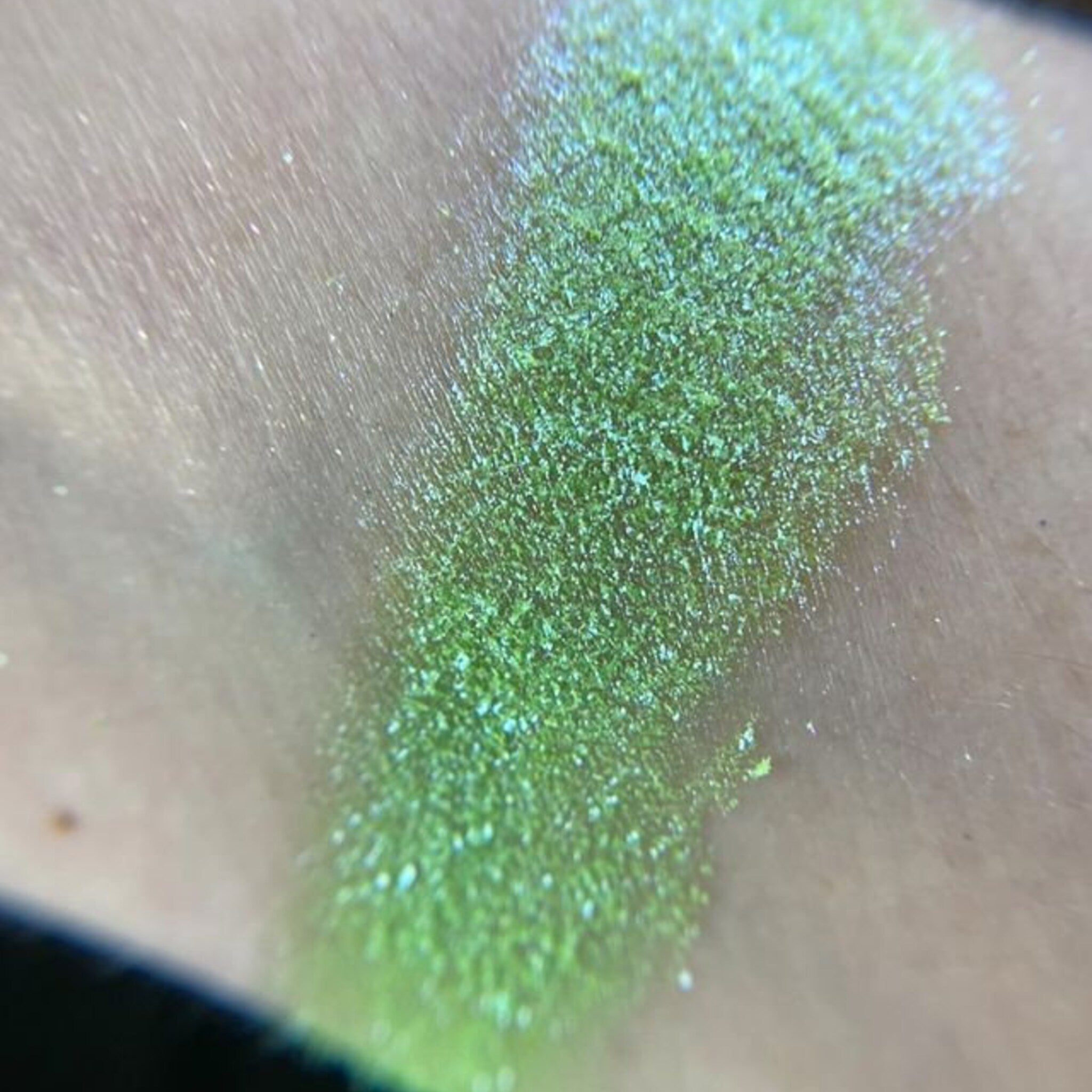 Side view of Globetrotter Eye Shadow Palette showcasing 12 vibrant matte and shimmer shades in circular pans