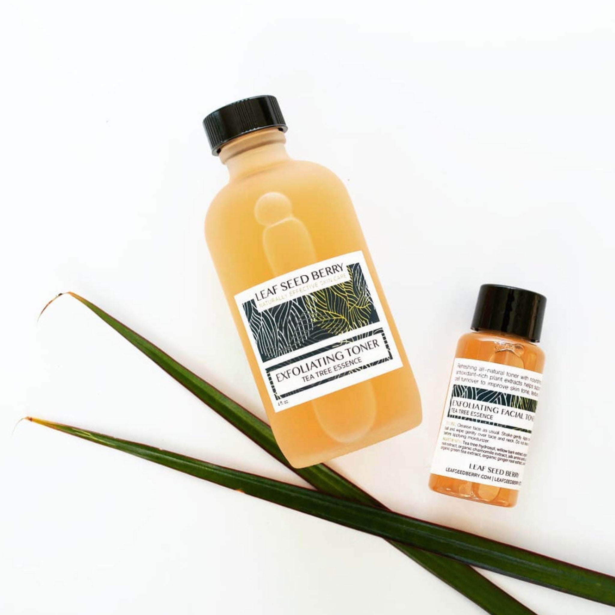 Toner bottles with black caps, yellow liquid, and Leaf Seed Berry label, with green leaves