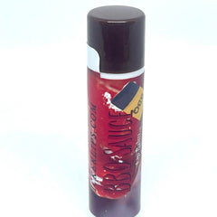Lip balm tube with brown cap, red body, and BBQ SAUCE text on the label