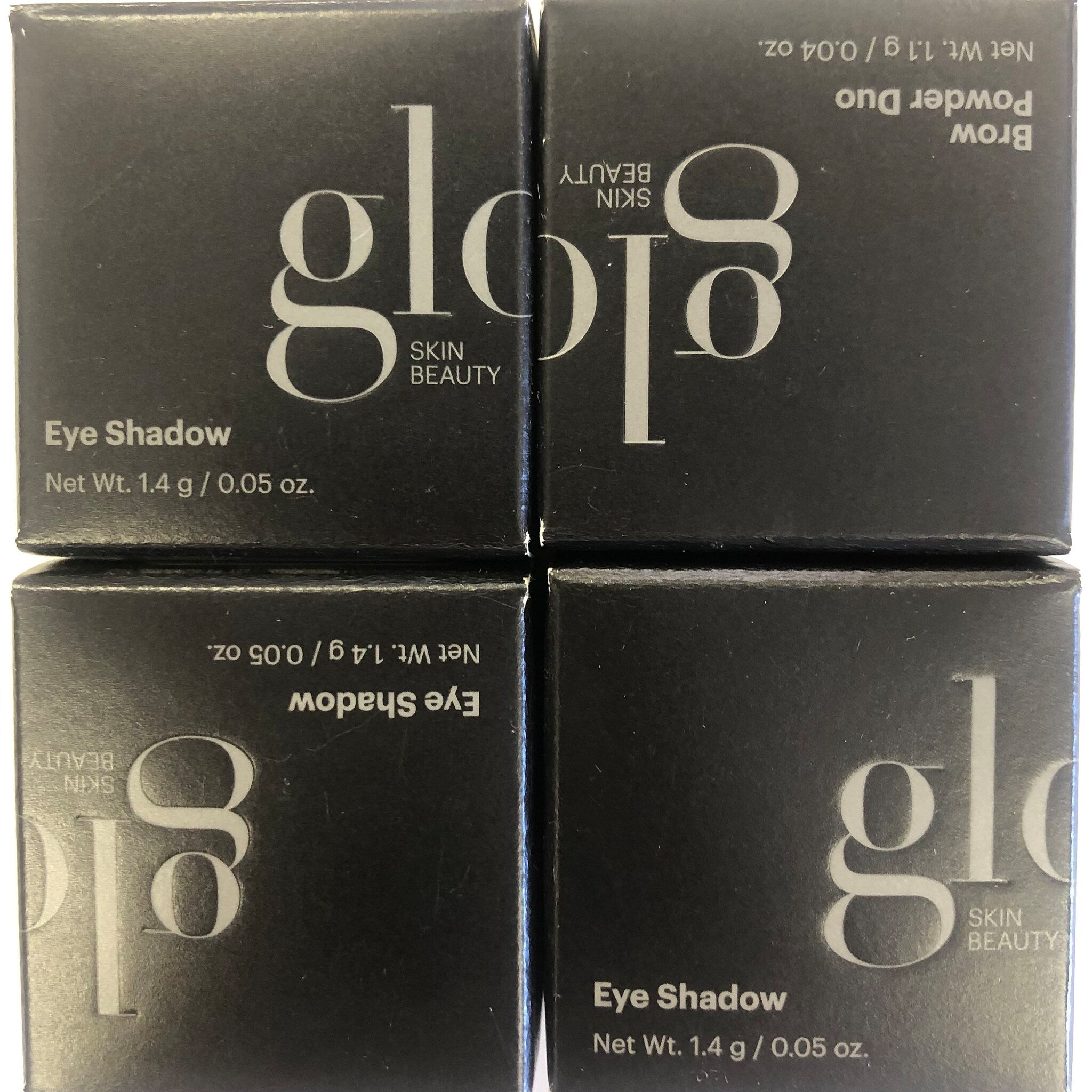 Side view of Glo Skin Beauty Eye Shadow compact showing sleek black packaging and product thickness