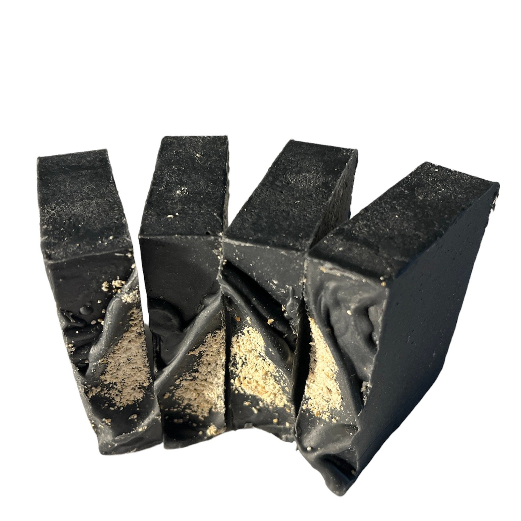 Activated charcoal soap bars, black rectangular shape, with light brown flecks, four pieces