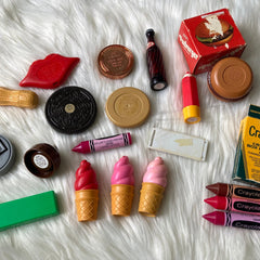 Side view of vintage 70s Avon collectible compact showing glossy lip balm nestled in gold-toned case with floral detailing