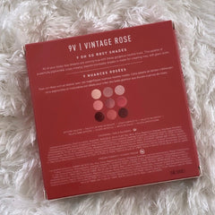 Side view of Vintage Rose 9V Eye Shadow palette showing nine rosy powder shades in rectangular pans with gold trim