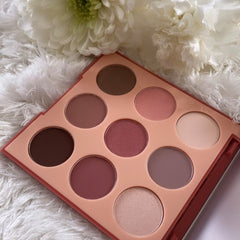 Close-up of Vintage Rose 9V Eye Shadow pan showing soft matte pink powder with subtle shimmer particles